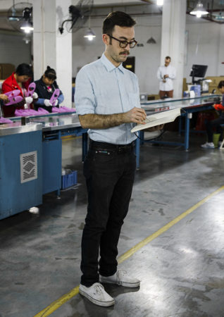 Thomas sketching at a factory in Dongguan China, 2014 - Photo By Philippe Fragniere